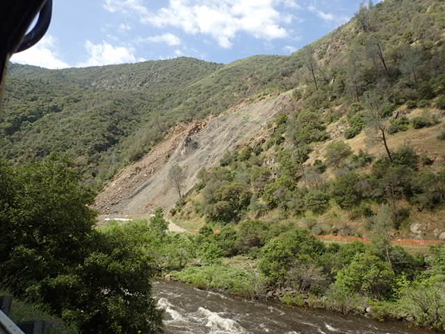 A recent earthquake damaged the hillside netting used to stabilize the hillside. 